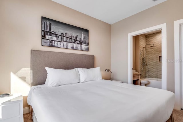 carpeted bedroom featuring ensuite bath