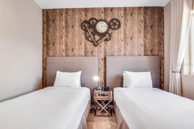 bedroom with carpet floors and wooden walls