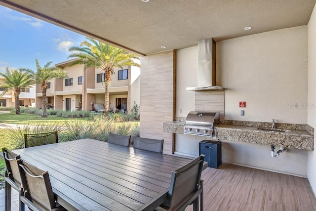 view of patio / terrace with outdoor dining area, a sink, a grill, and area for grilling