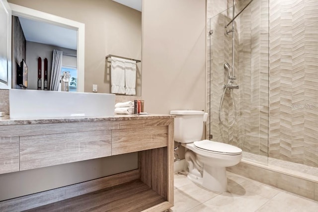 full bath with tile patterned floors, vanity, toilet, and walk in shower