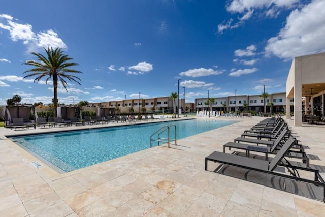 community pool featuring a patio area and a residential view