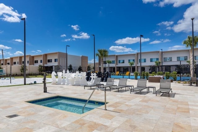 view of pool featuring a patio area and a hot tub