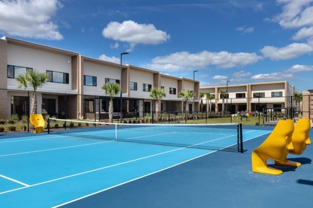 view of tennis court featuring fence