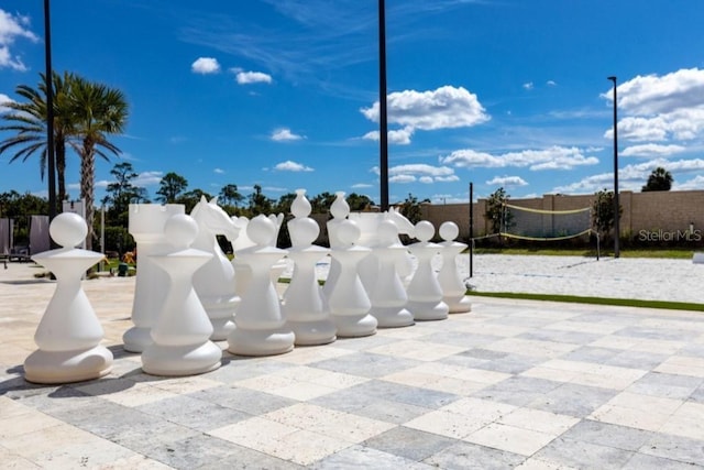 surrounding community featuring fence and volleyball court