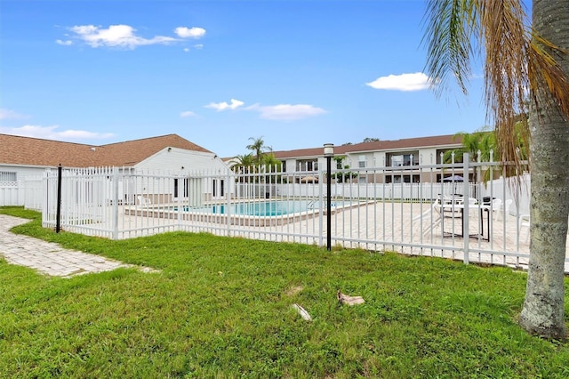 view of yard featuring a patio area, fence, and a community pool