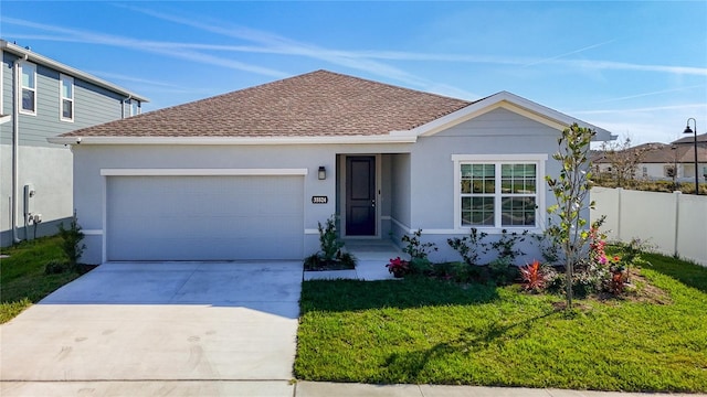 ranch-style home featuring an attached garage, fence, driveway, stucco siding, and a front lawn