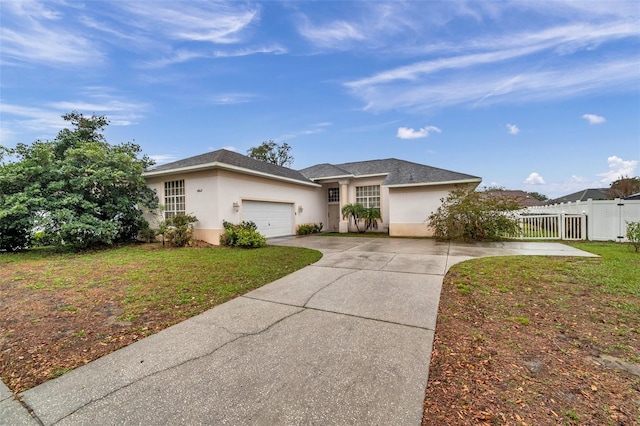 ranch-style house featuring a garage, driveway, stucco siding, fence, and a front yard