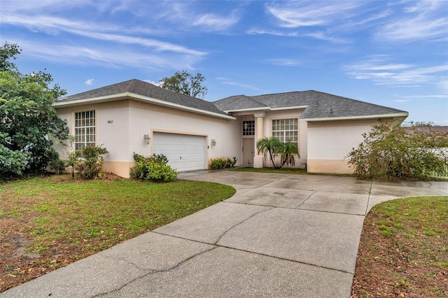 ranch-style house with a garage, concrete driveway, a front lawn, and stucco siding