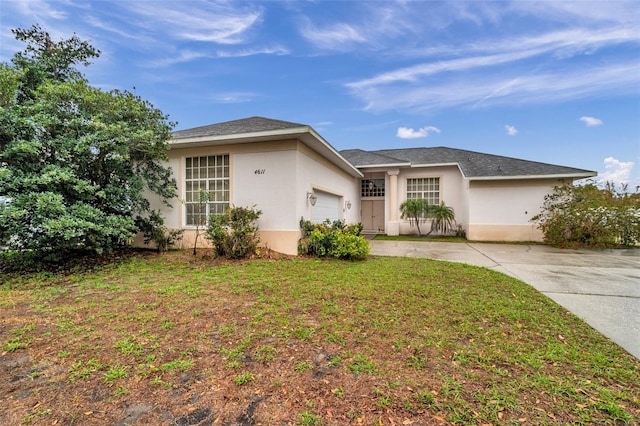 single story home with a garage, driveway, a front lawn, and stucco siding