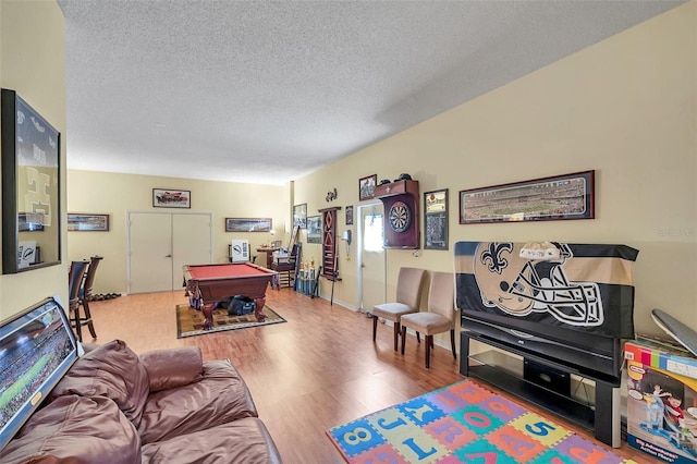 recreation room featuring billiards, a textured ceiling, and wood finished floors