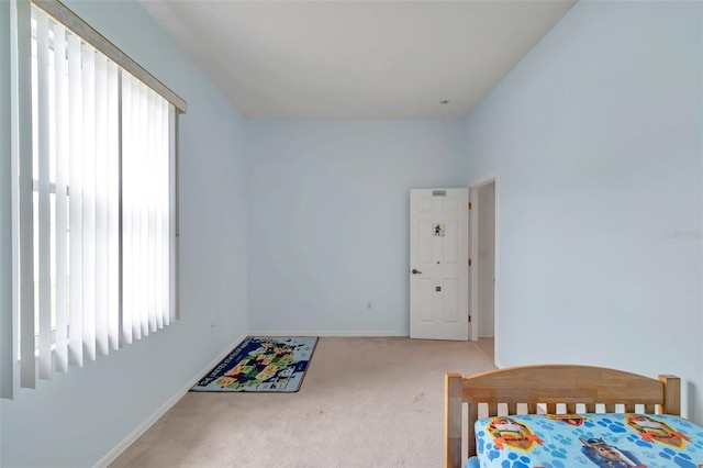 carpeted bedroom featuring baseboards