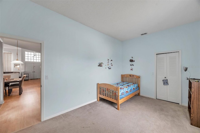 carpeted bedroom with baseboards and visible vents