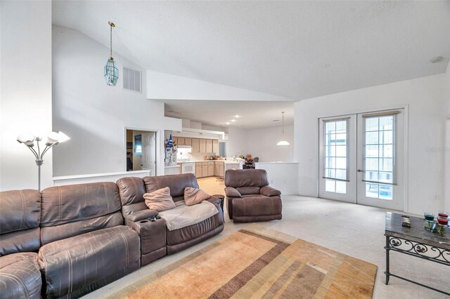 living area with french doors, light colored carpet, vaulted ceiling, and visible vents