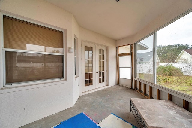 unfurnished sunroom with french doors