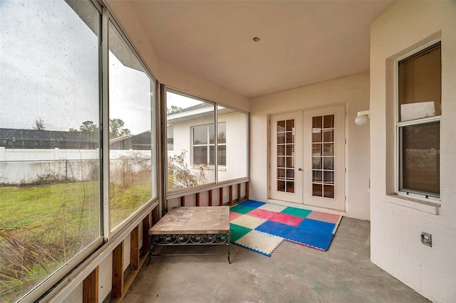 sunroom / solarium featuring french doors