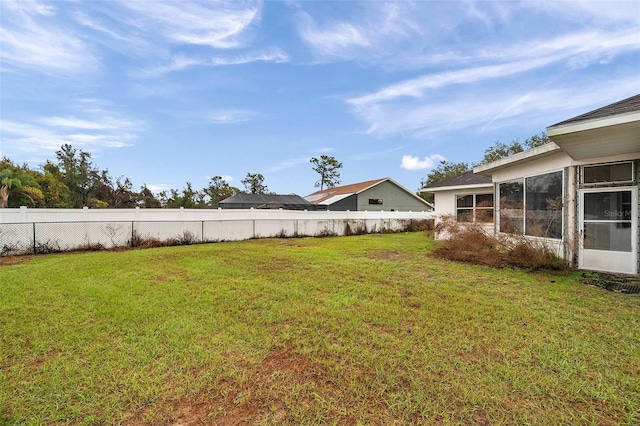 view of yard with a sunroom and fence