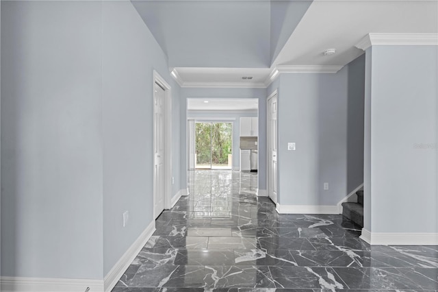 corridor featuring baseboards, marble finish floor, and crown molding