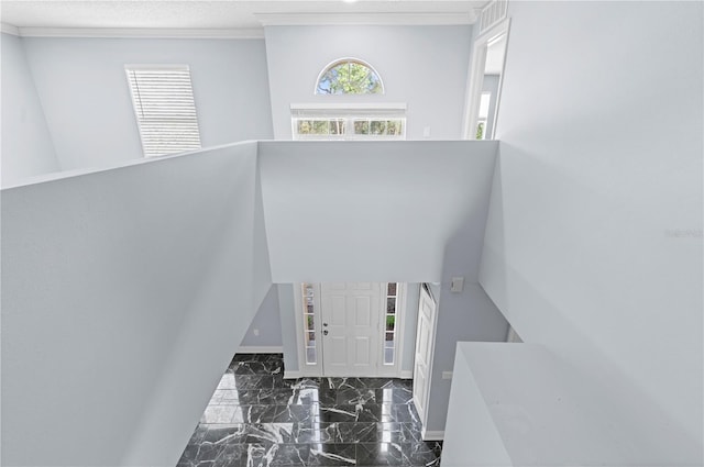 foyer with visible vents, marble finish floor, a wealth of natural light, and baseboards