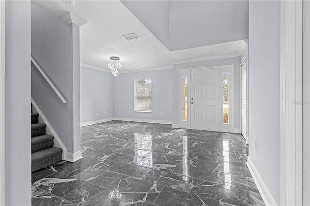 foyer entrance with baseboards, marble finish floor, ornamental molding, and stairs