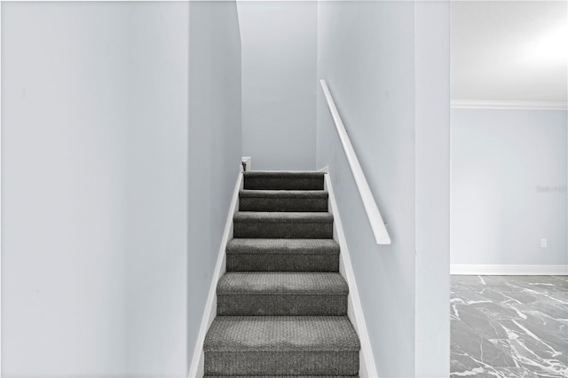 stairs featuring marble finish floor, crown molding, and baseboards