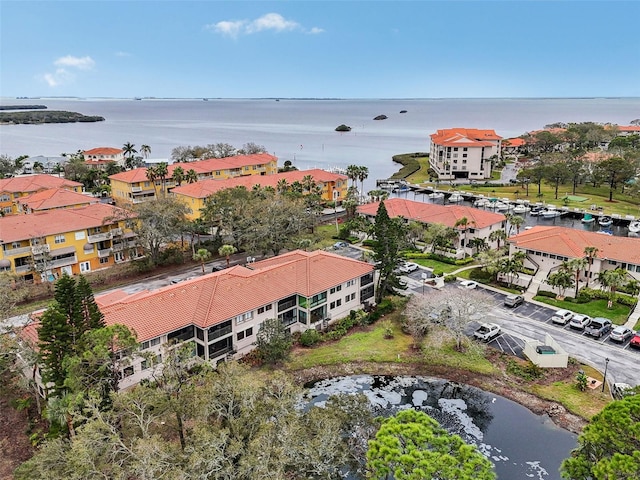 drone / aerial view featuring a water view and a residential view