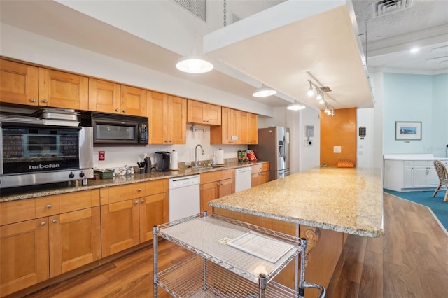 kitchen with black microwave, white dishwasher, a kitchen bar, and stainless steel fridge with ice dispenser