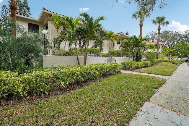 exterior space with a fenced front yard and a lawn