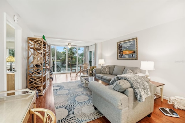 living area featuring floor to ceiling windows and wood finished floors