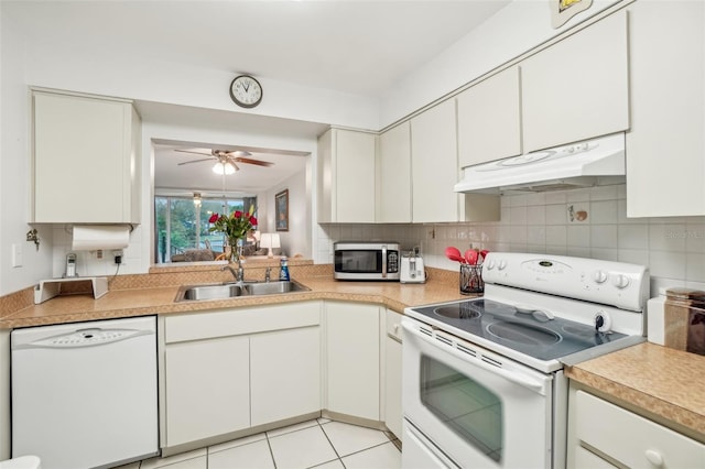 kitchen with light countertops, white cabinetry, a sink, white appliances, and under cabinet range hood