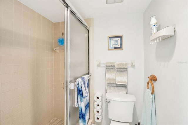 full bath featuring a shower stall and toilet