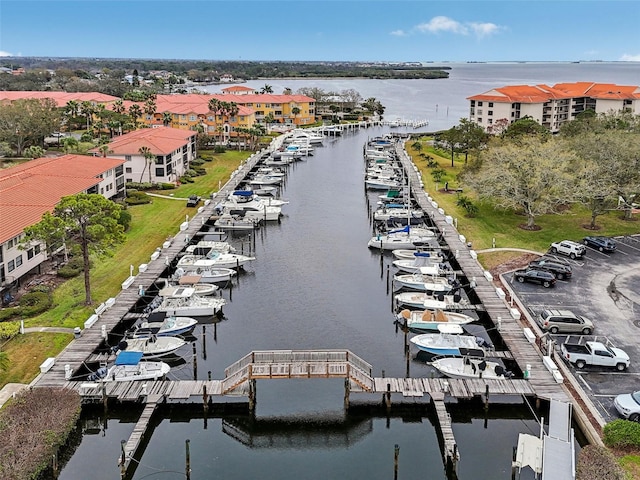 drone / aerial view with a water view and a residential view