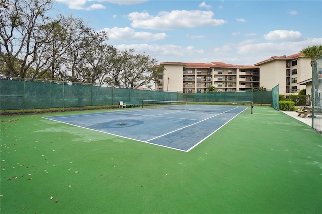 view of tennis court with fence