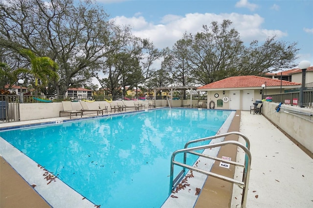 pool featuring a patio and fence