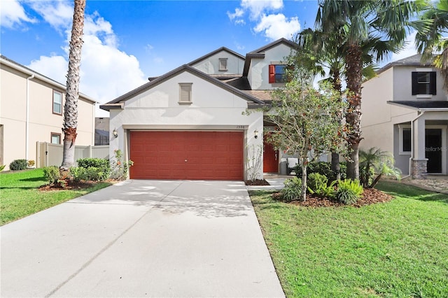 view of front of home featuring a garage, a front yard, driveway, and stucco siding