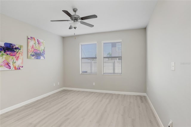 spare room with light wood-style flooring, baseboards, and ceiling fan