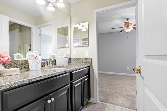 bathroom with ceiling fan, vanity, and baseboards