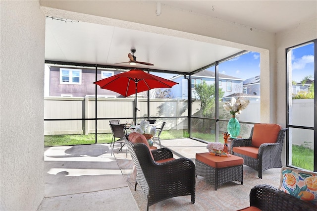 sunroom / solarium featuring a wealth of natural light and ceiling fan