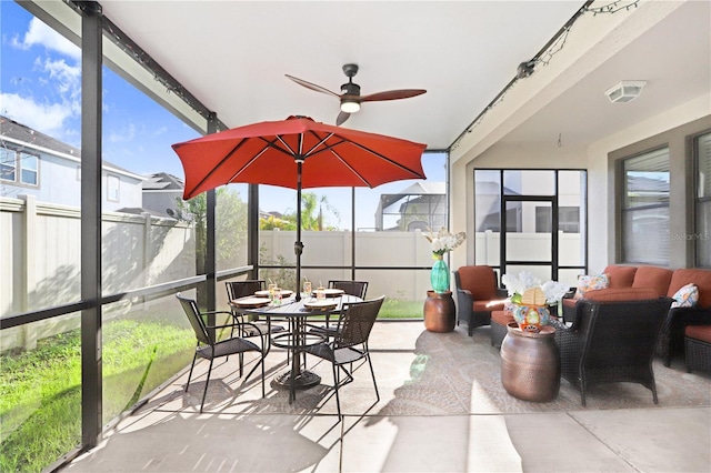 sunroom / solarium featuring visible vents and ceiling fan