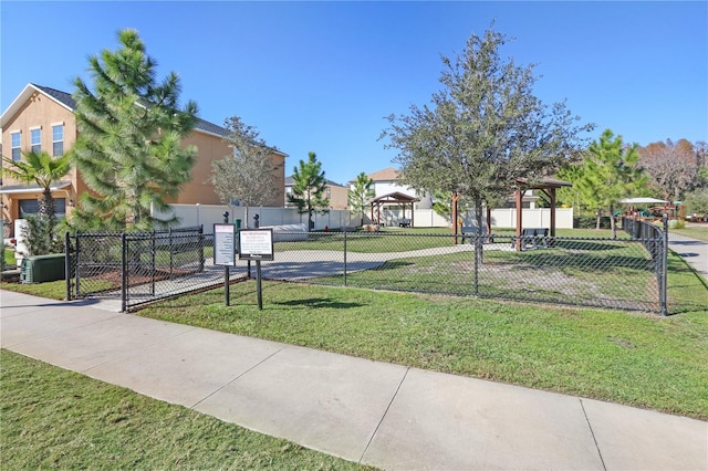 view of home's community featuring a lawn, fence, and a residential view