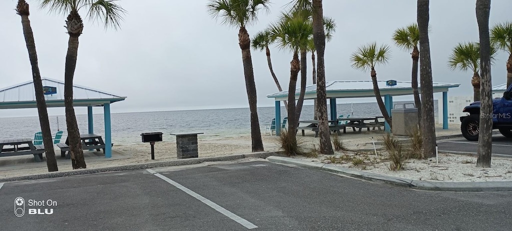 view of dock featuring a gazebo and a water view