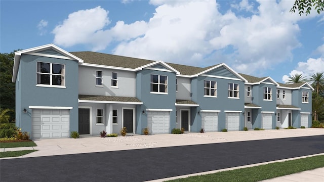 view of property with a garage, a residential view, concrete driveway, and stucco siding