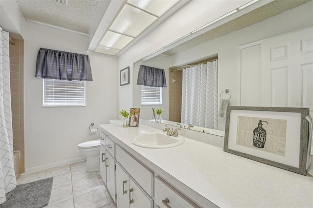 bathroom featuring a textured ceiling, tile patterned flooring, toilet, vanity, and baseboards