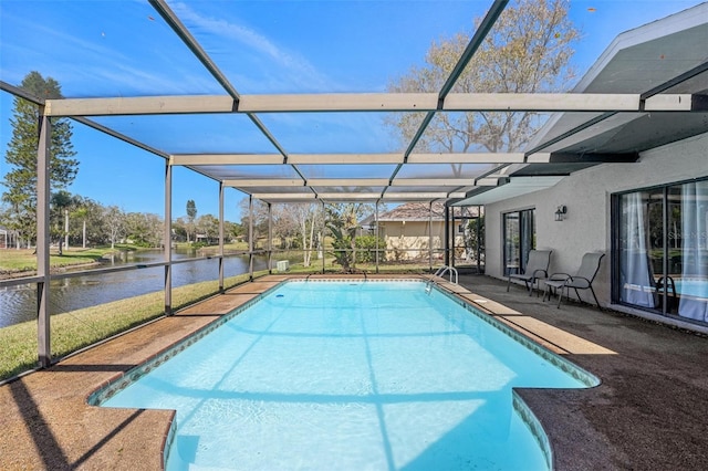 pool with a lanai and a water view