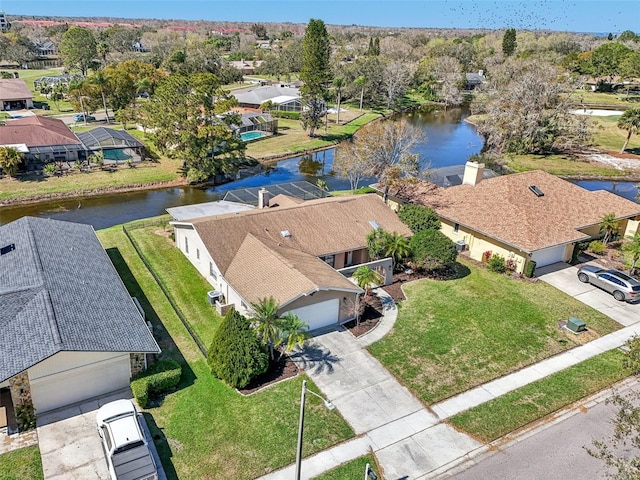 birds eye view of property with a water view and a residential view