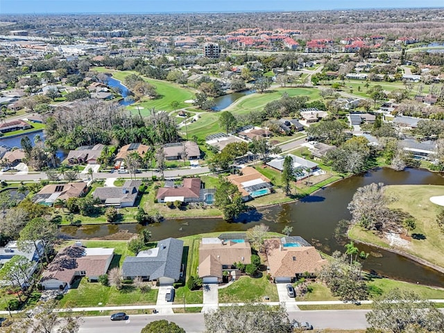 aerial view featuring golf course view, a water view, and a residential view