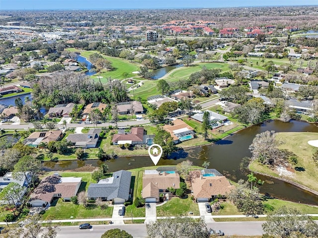 aerial view featuring a water view, view of golf course, and a residential view