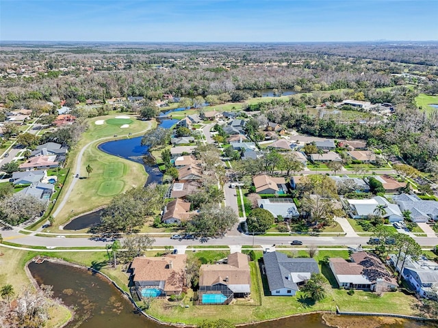 drone / aerial view featuring a residential view, a water view, and golf course view