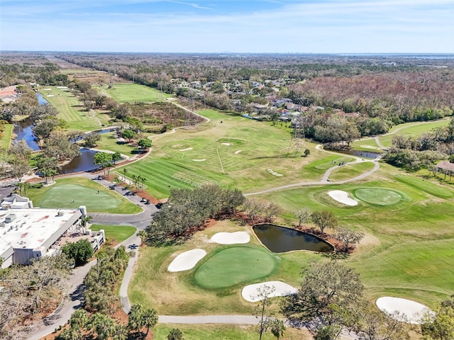 aerial view with golf course view and a water view