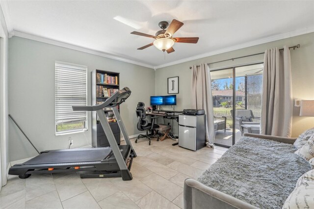 workout area with crown molding, ceiling fan, baseboards, and light tile patterned floors