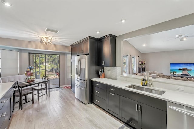 kitchen with a sink, light countertops, and appliances with stainless steel finishes